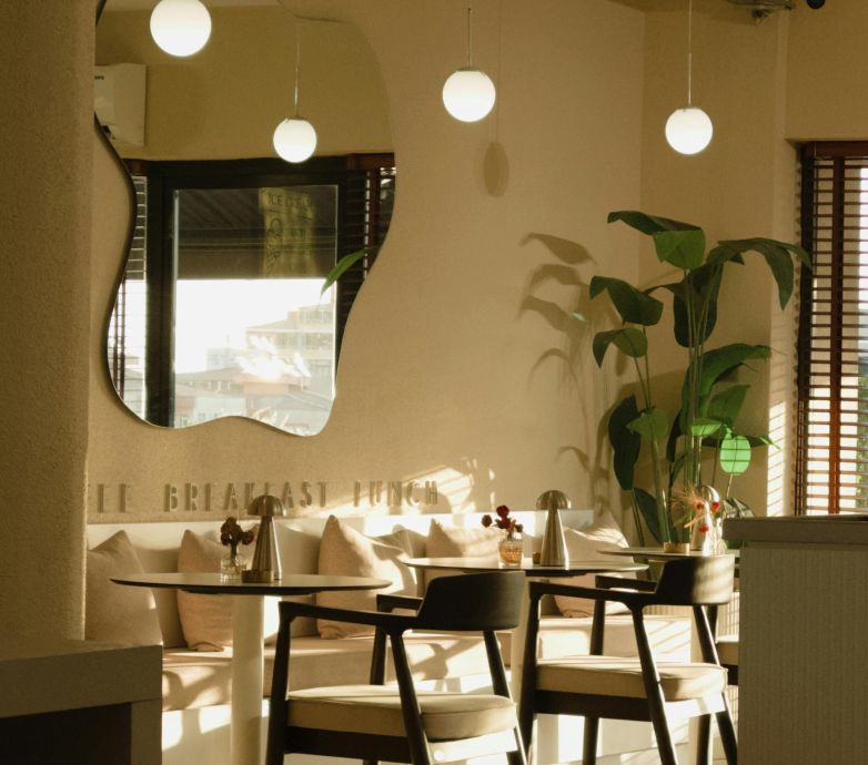 Warmly lit cafe interior with modern design and elegant decor, perfect for a relaxing meal.